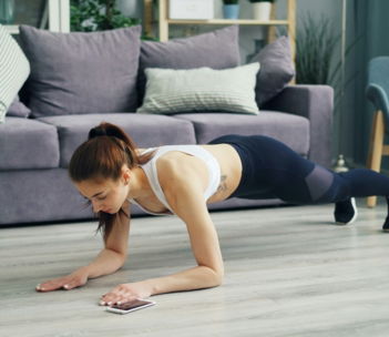 a woman is doing push ups on the floor